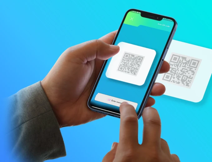 A phone scanning a QR code to pay.